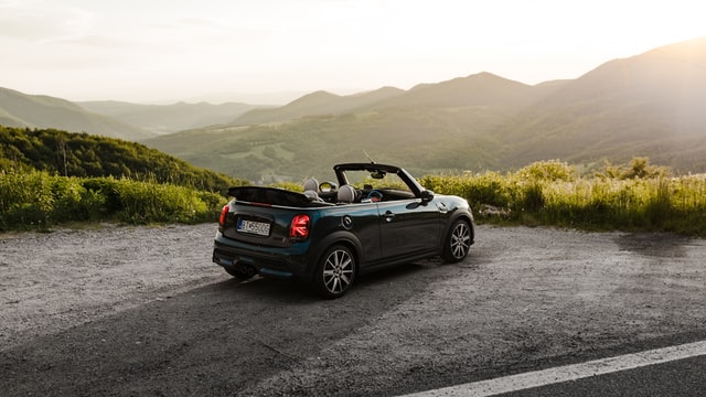 Black convertible car parked on road side